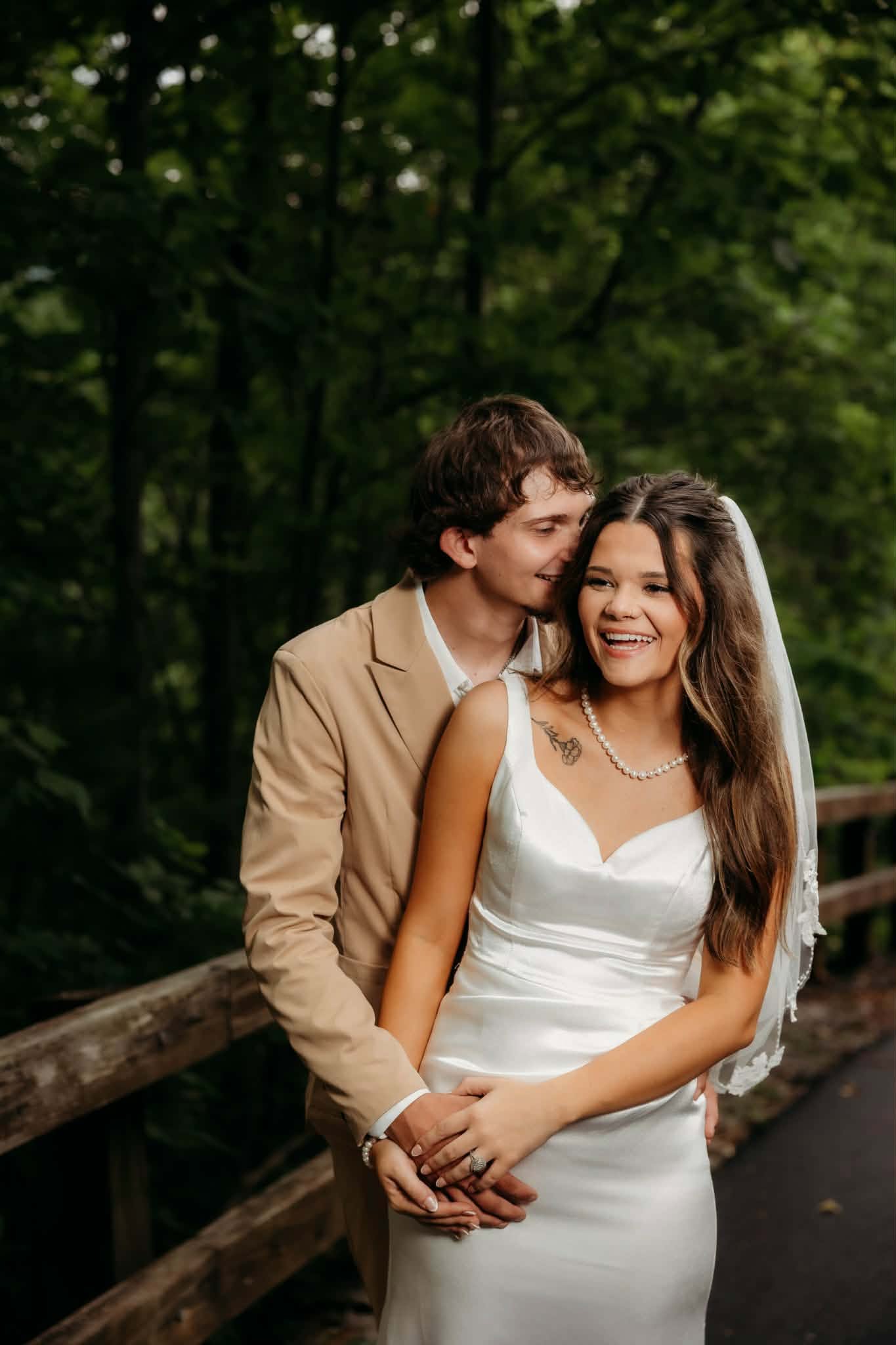 Groom kissing the head of his smiling bride