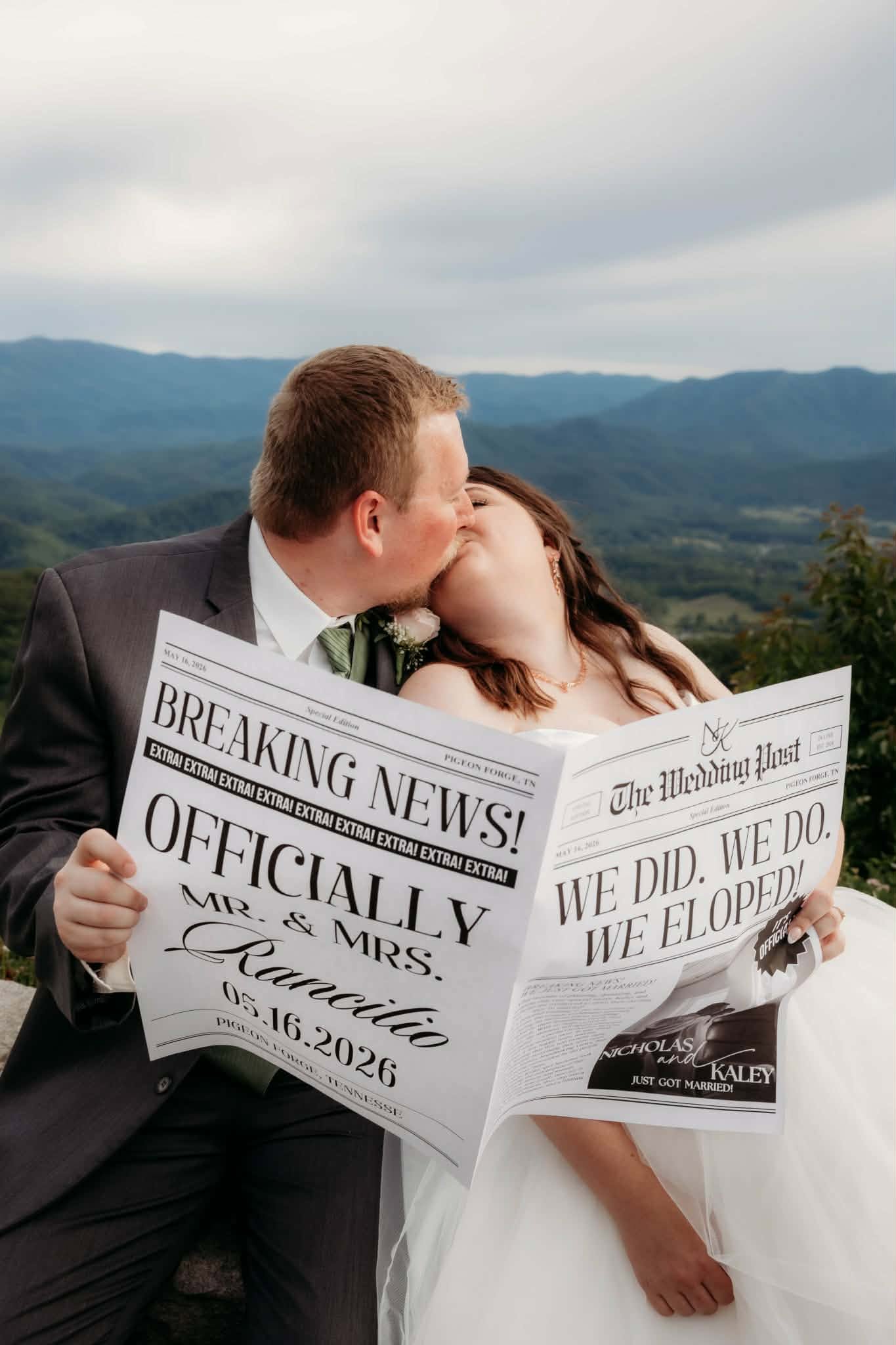 Eloping couple kissing behind a playful newspaper announcement