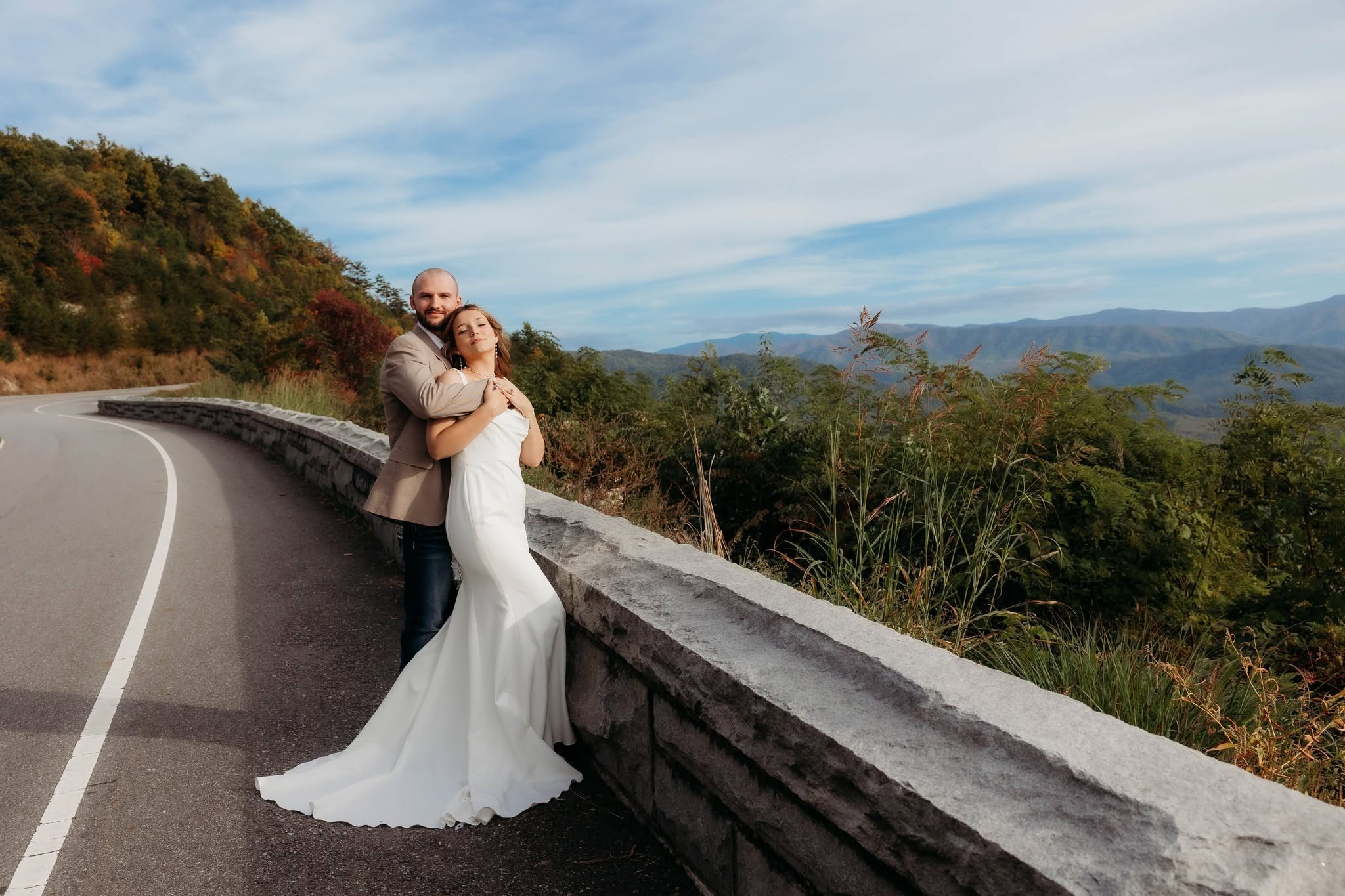 A newlywed couple overlooking the Great Smoky Mountains from Foothills Parkway